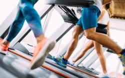 Persone che corrono sui tapis roulant in palestra.